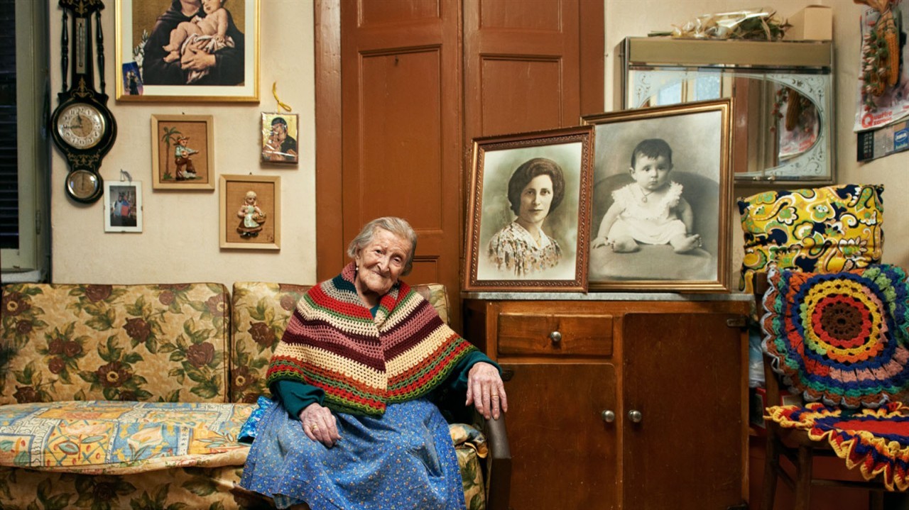 An elderly woman sitting on a couch